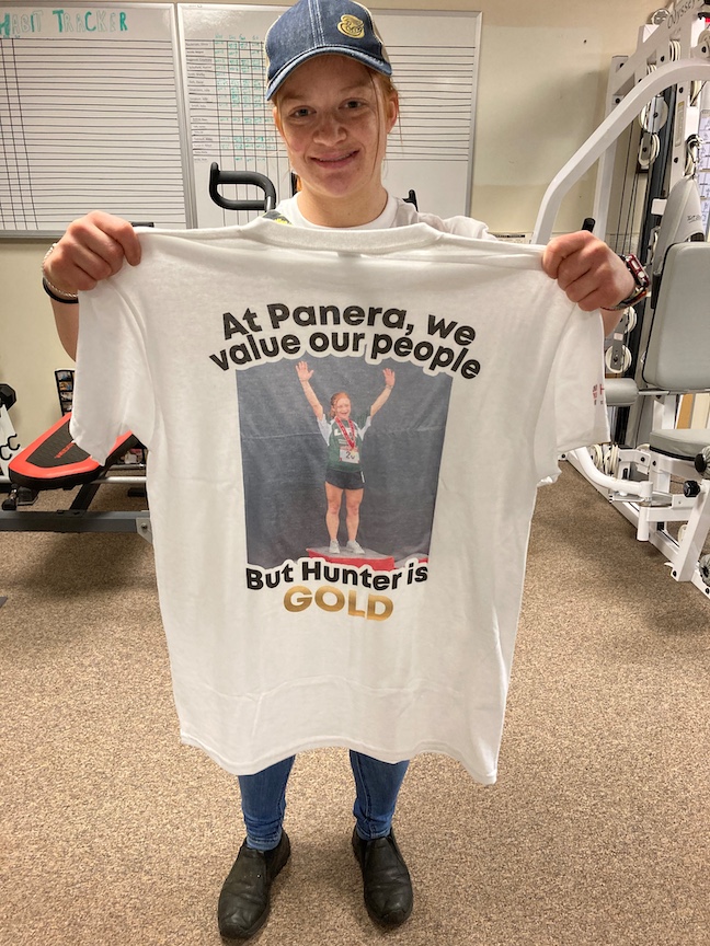 Hunter holds t-shire with message: At Panera, we value our people. But Hunter is gold.: